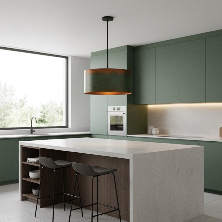 Modern kitchen with green cabinets, white island, and black pendant light.