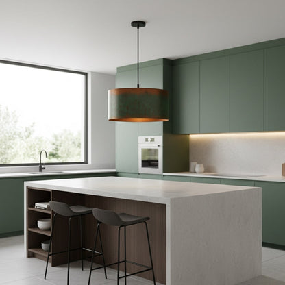 Modern kitchen with green cabinets, white island, and black pendant light.