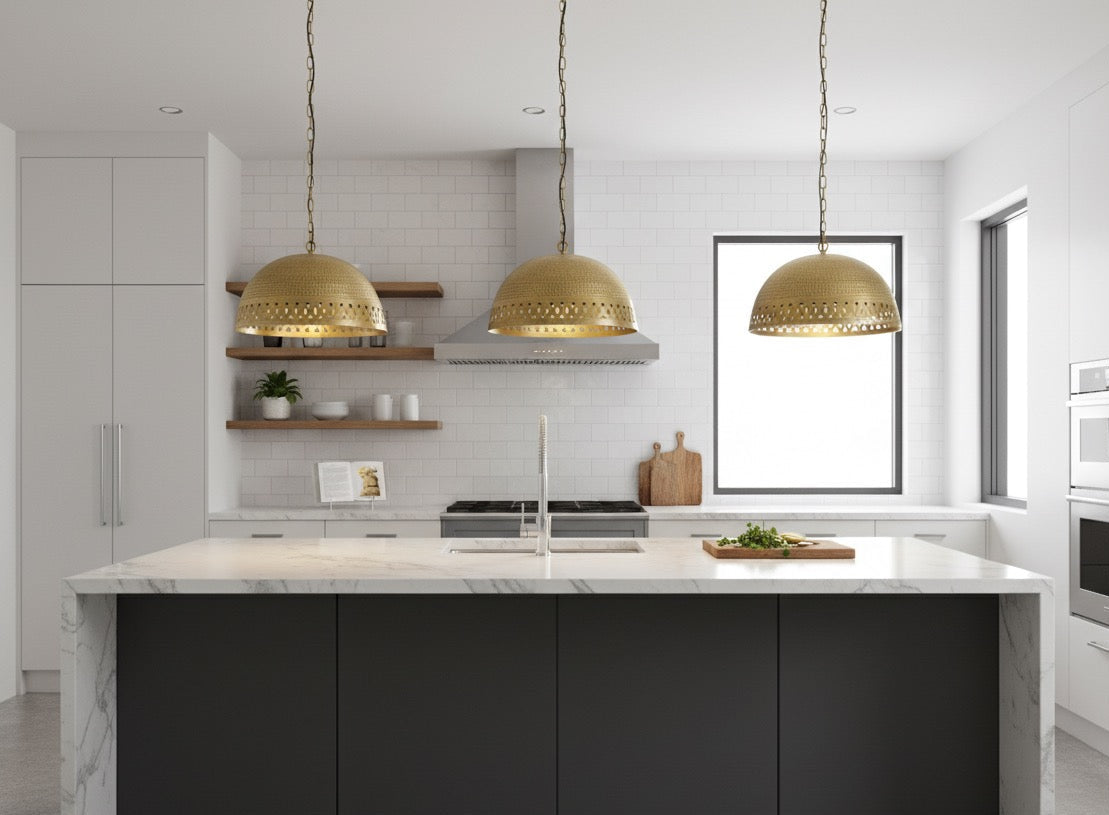 Modern kitchen with marble island, gold pendant lights, and white cabinets.