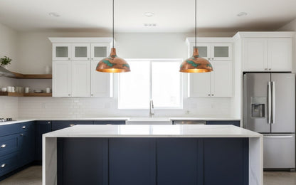 Modern kitchen with white cabinets, a blue island, and stainless steel appliances.