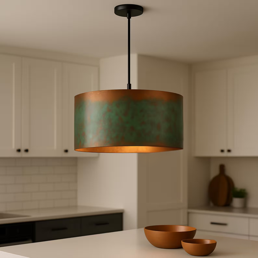 Copper pendant light hanging in a kitchen with white cabinets and a countertop.