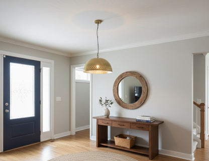 Foyer with a wooden console table, round mirror, and blue door.